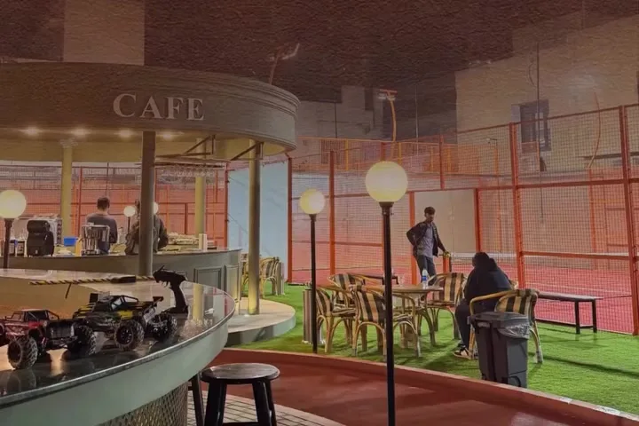 The café counter at Club44 beside the lawn and padel court